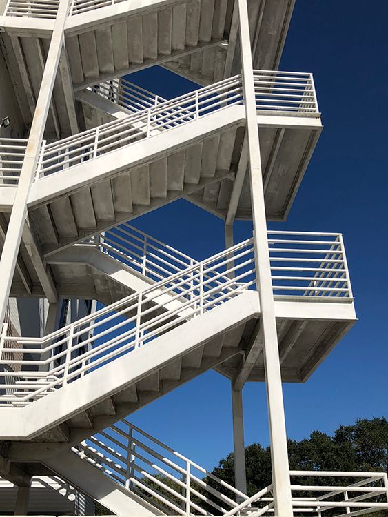 steel fire exit stair with pipe railing in a Pine Castle building