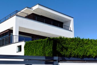 modern multi-floor home with horizontal balcony railings