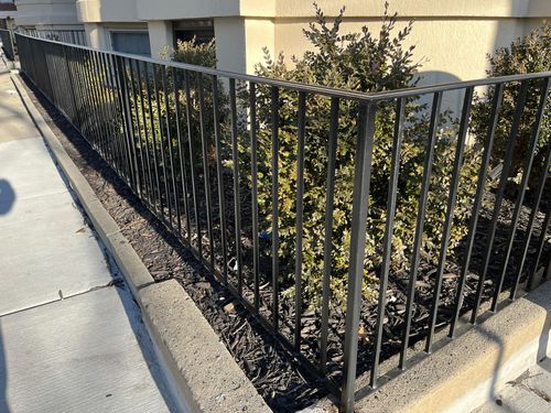 wrought iron fence around property garden