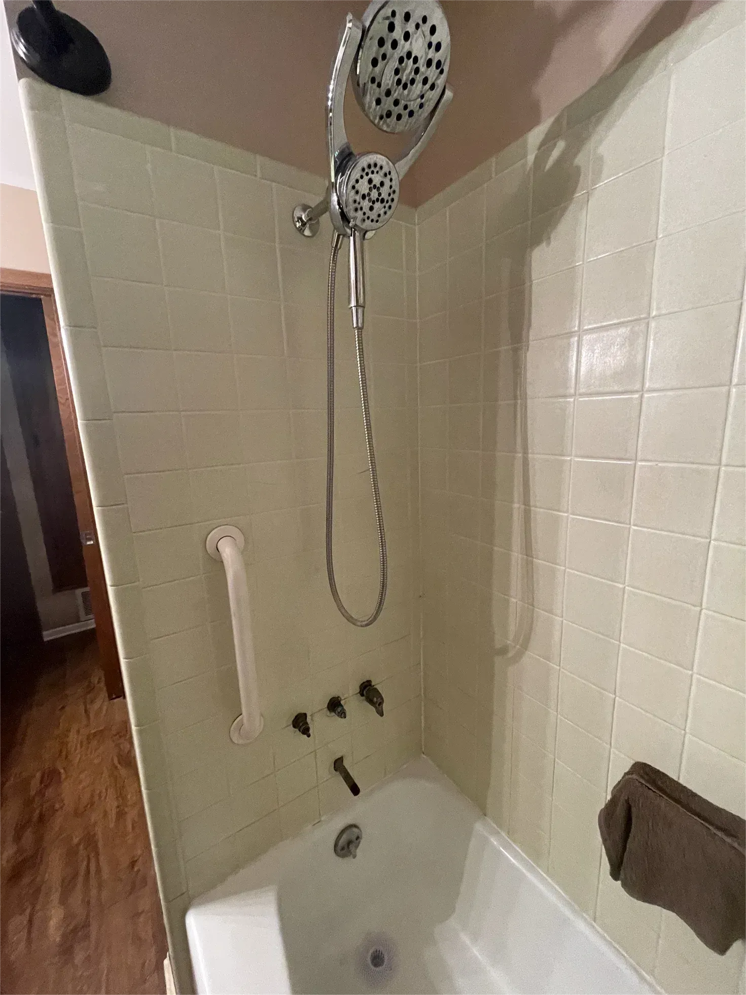 A bathroom with a bathtub and a shower head.