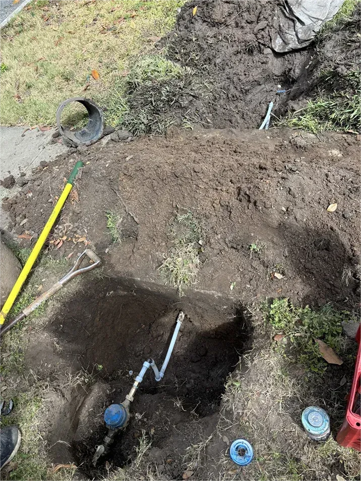 A person is digging a hole in the ground with a shovel.