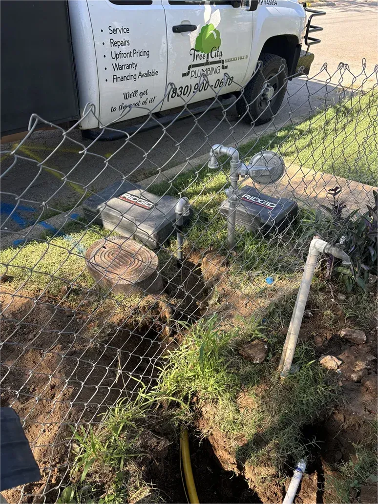 A white truck is parked next to a chain link fence.