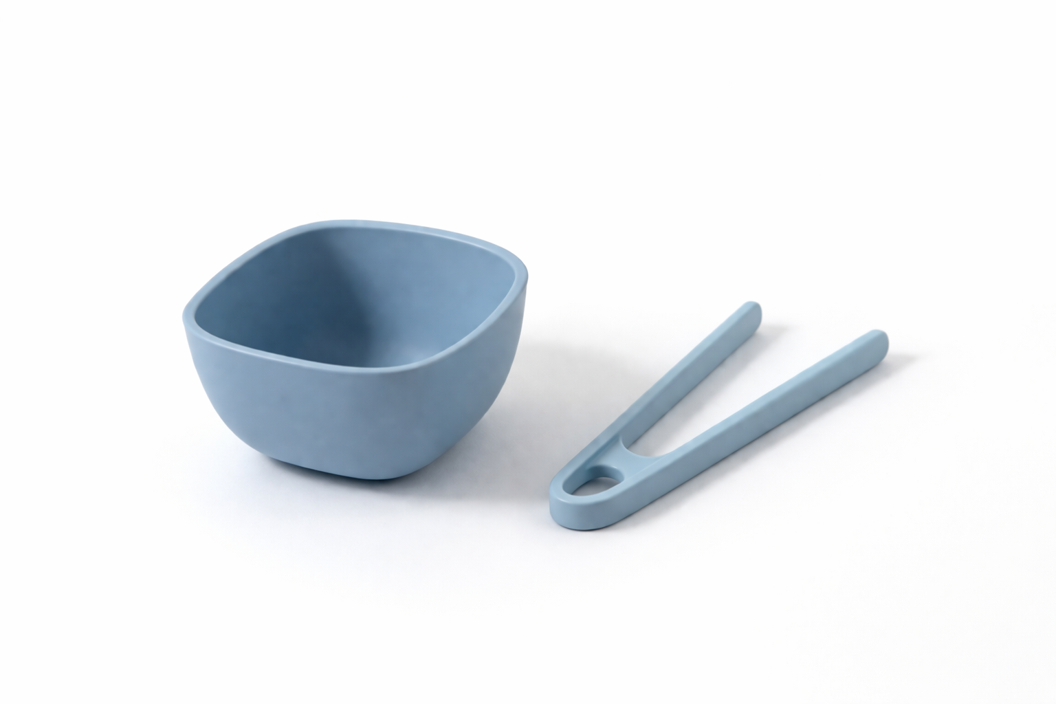Blue measuring cup and matching scoop on a white background