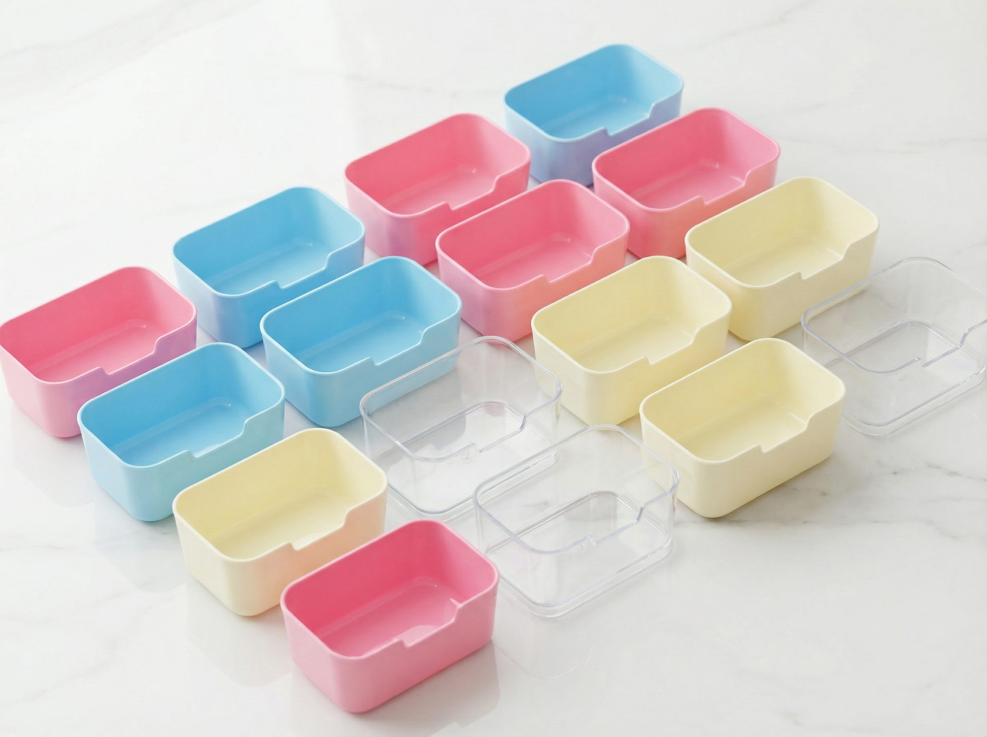 Sensorie Play sorting cups used for sensory organization, featuring pastel-colored containers filled with small felt balls and miniature farm animal figurines on a wooden table.