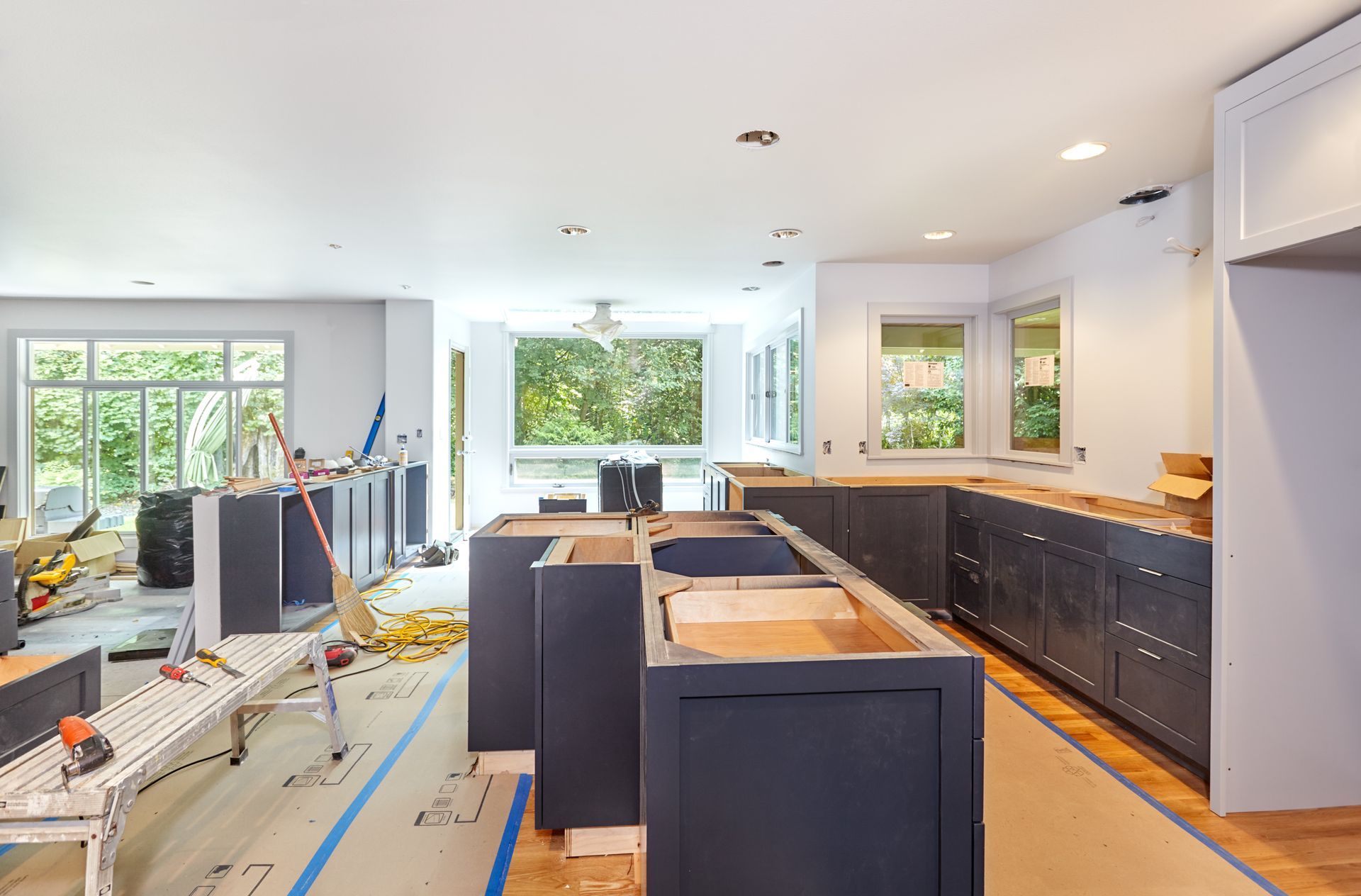 Installation of custom kitchen cabinets in progress.