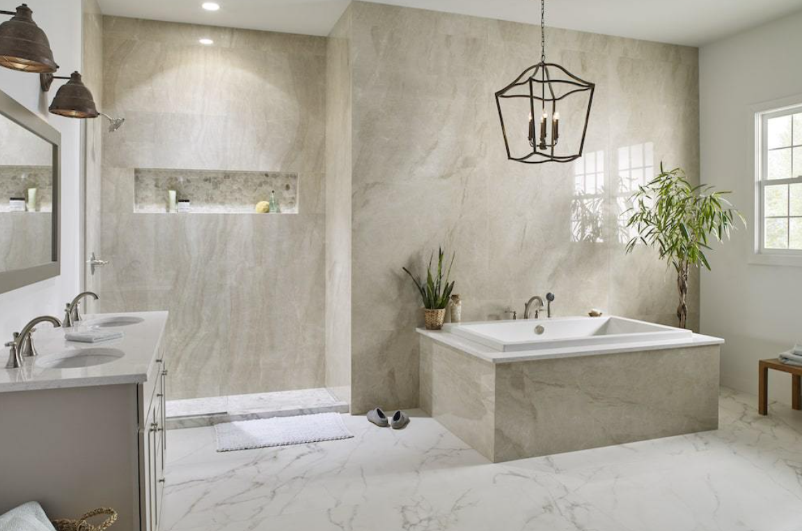 Modern beige bathroom with a freestanding tub, walk-in shower, double vanity, and hanging pendant lights