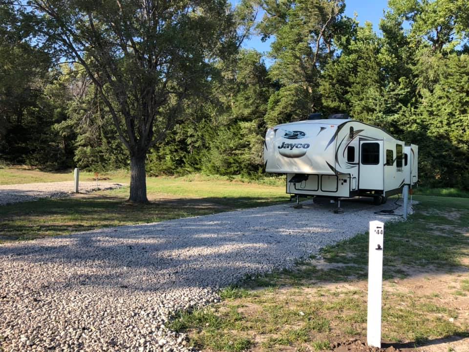 Camper Parked in gravel back in at Creek Side Resort in Hays, Kansas