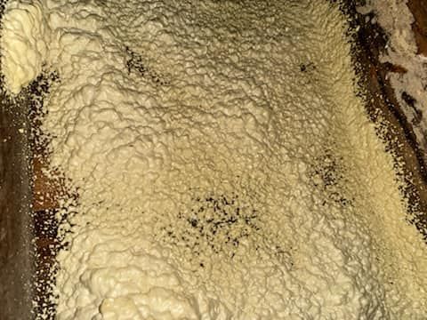 A close up of a piece of cake with a lot of foam on it.