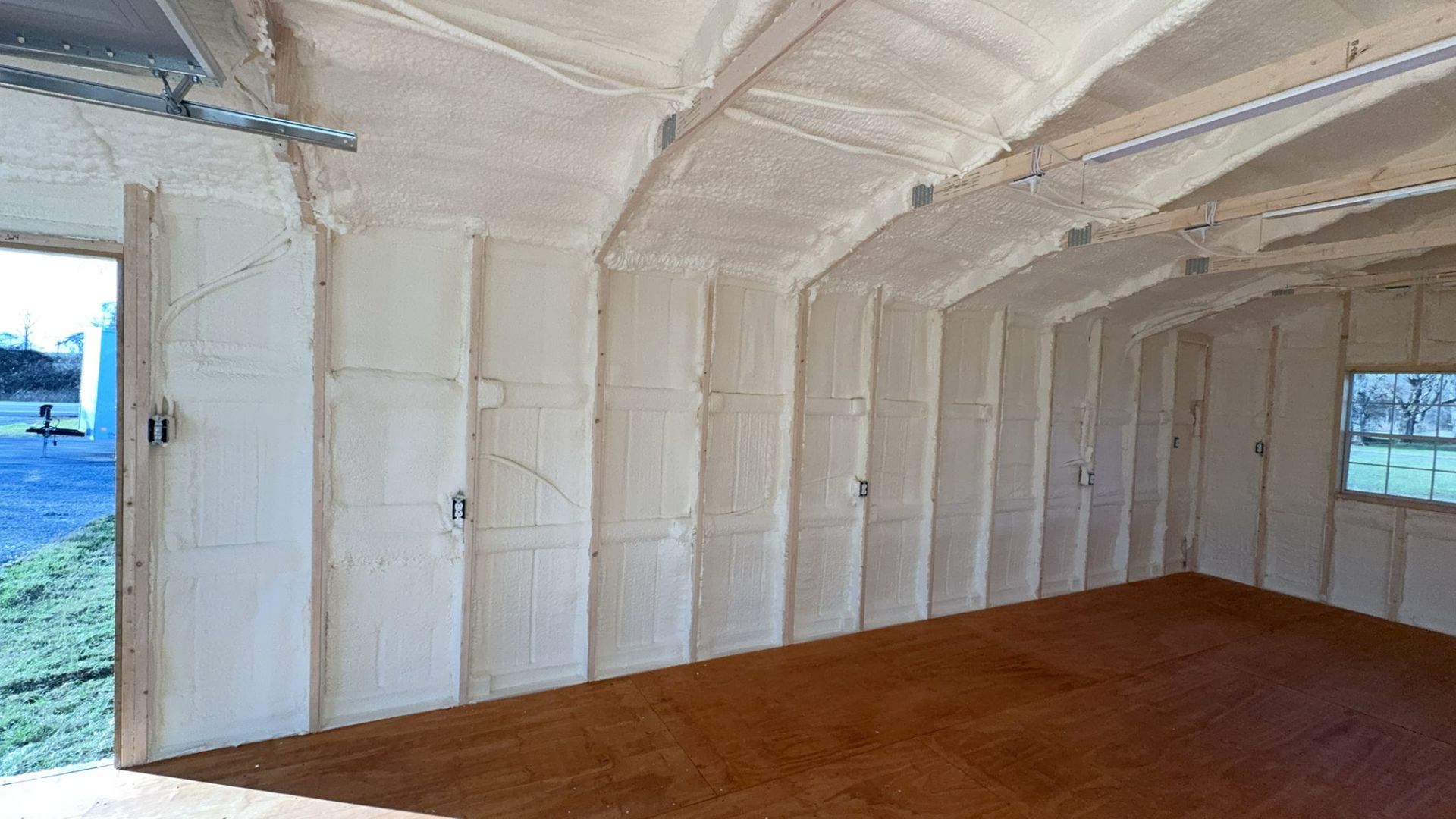 The inside of a garage with a lot of insulation on the walls and ceiling.