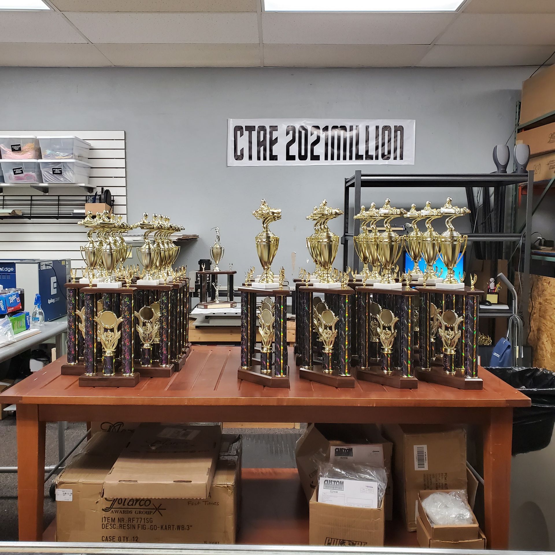 A table with trophies on it and a sign that says ctre 2021million