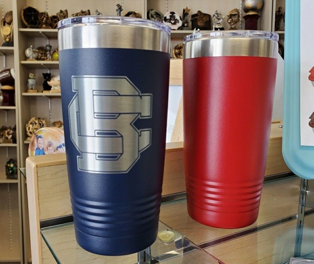 Two stainless steel tumblers with the letter s on them