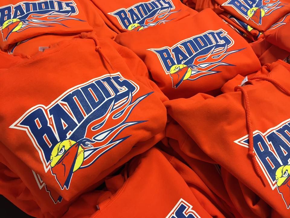 A bunch of orange bandits hoodies are stacked on top of each other