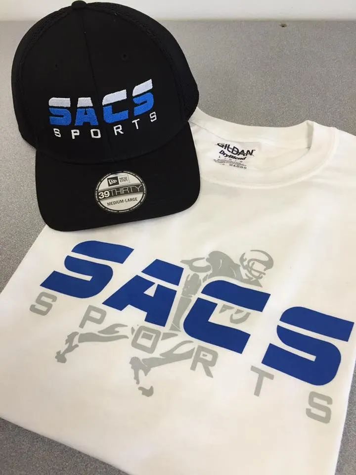 Black SACS Sports cap and white SACS Sports T-shirt with blue logo