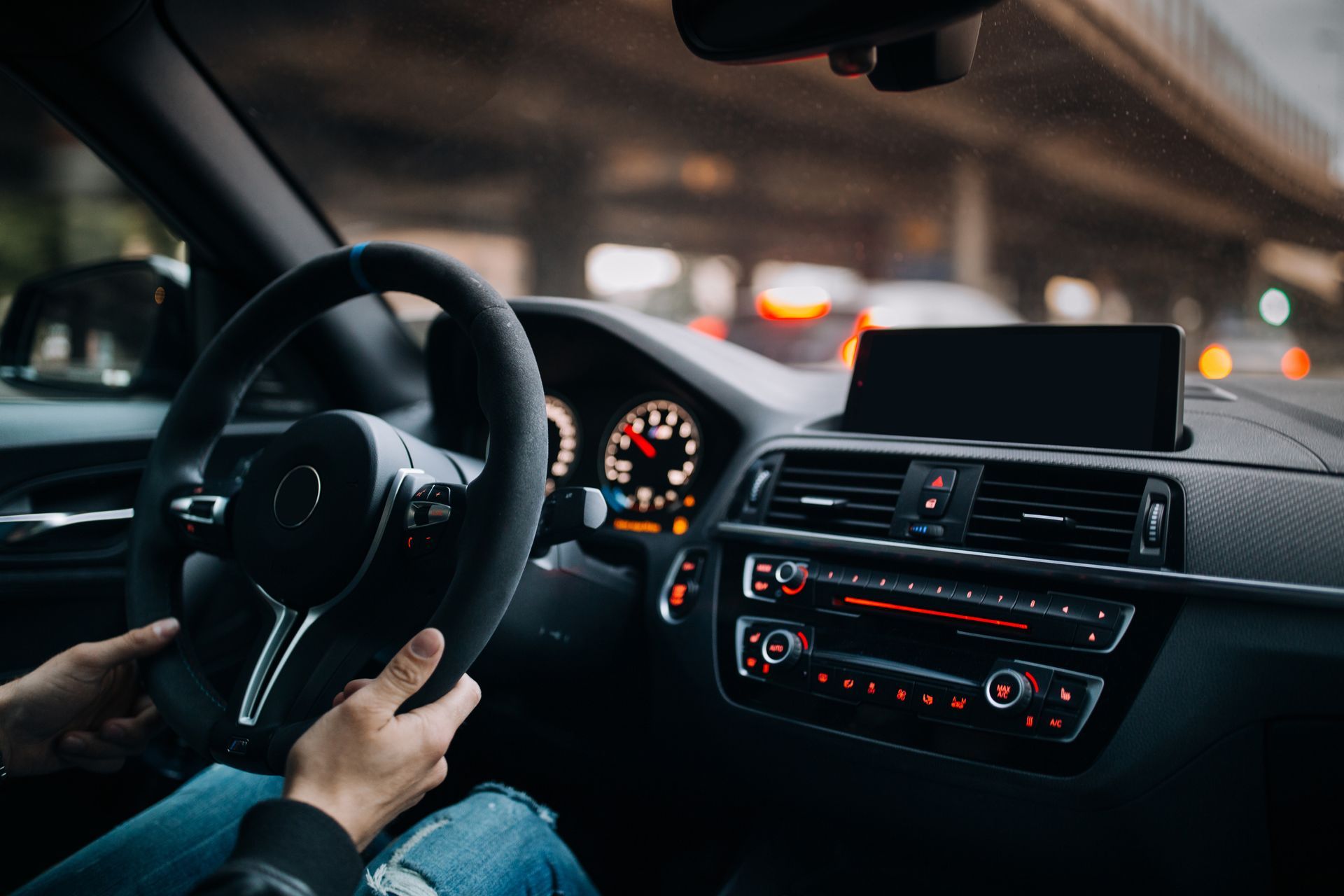 Hands on steering wheel inside a car