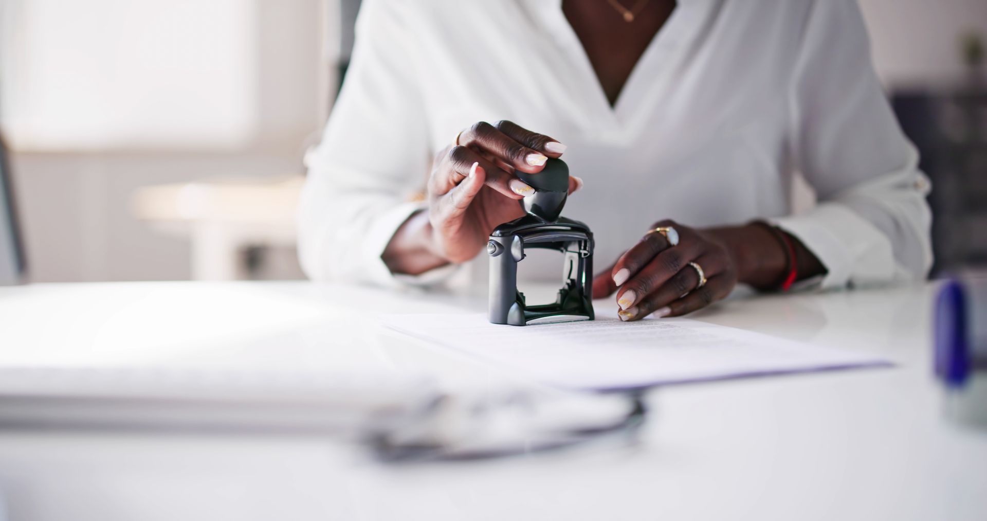 Person stamping a documen