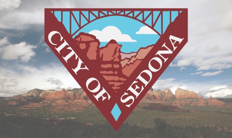 A logo for the city of sedona with mountains in the background