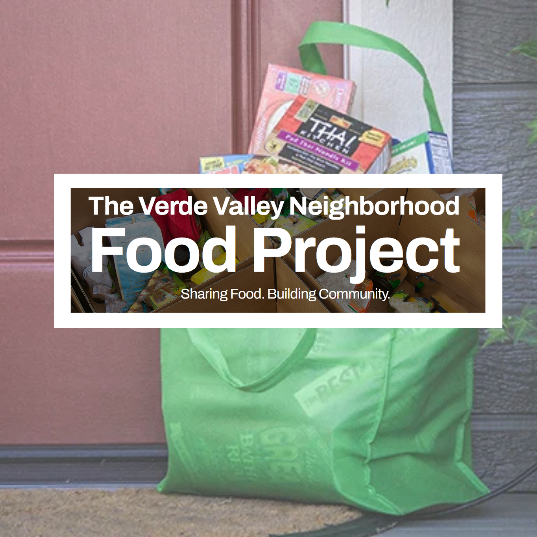 A green bag filled with food sits on a doorstep with a sign that says the verde valley neighborhood food project
