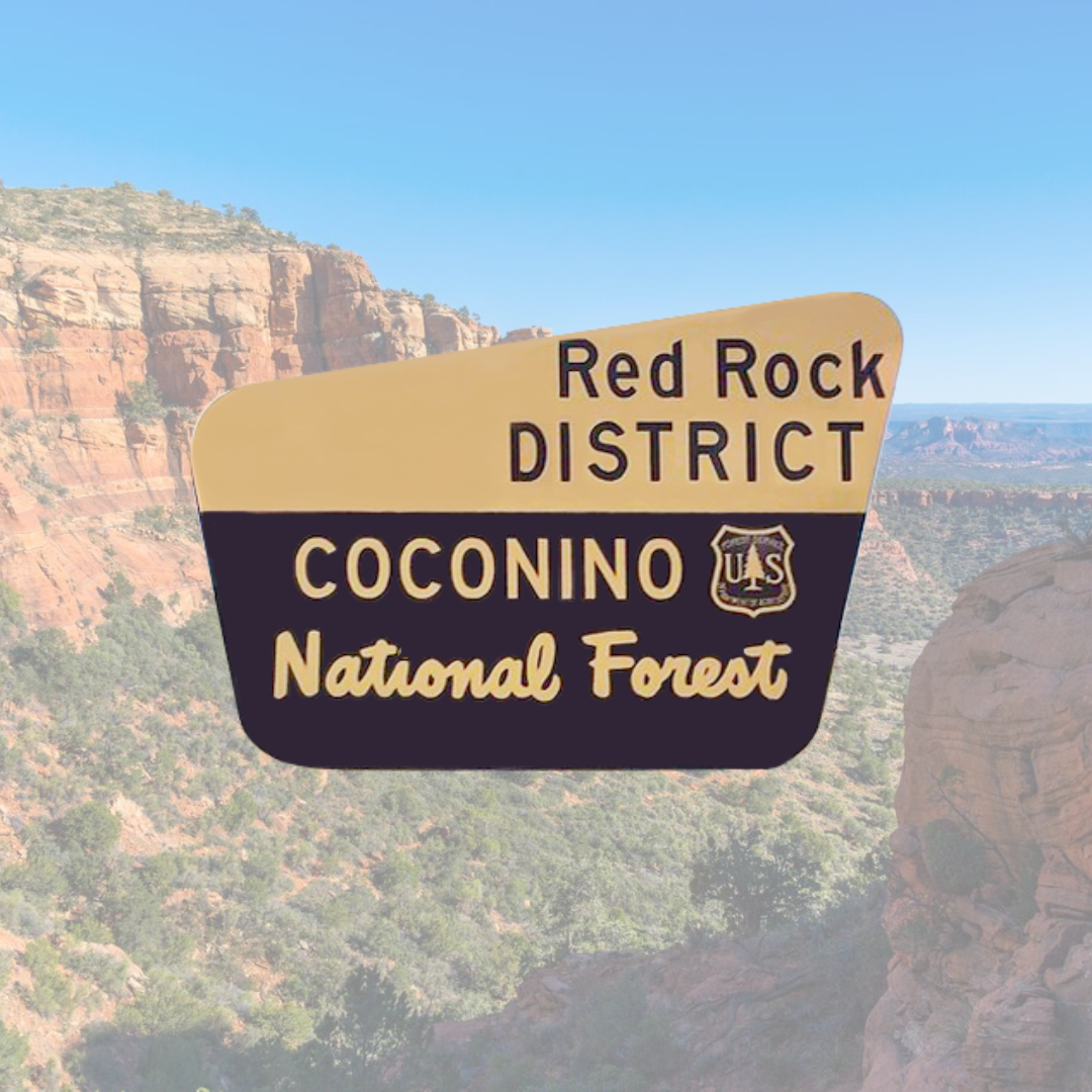 A sign for the red rock district coconino national forest