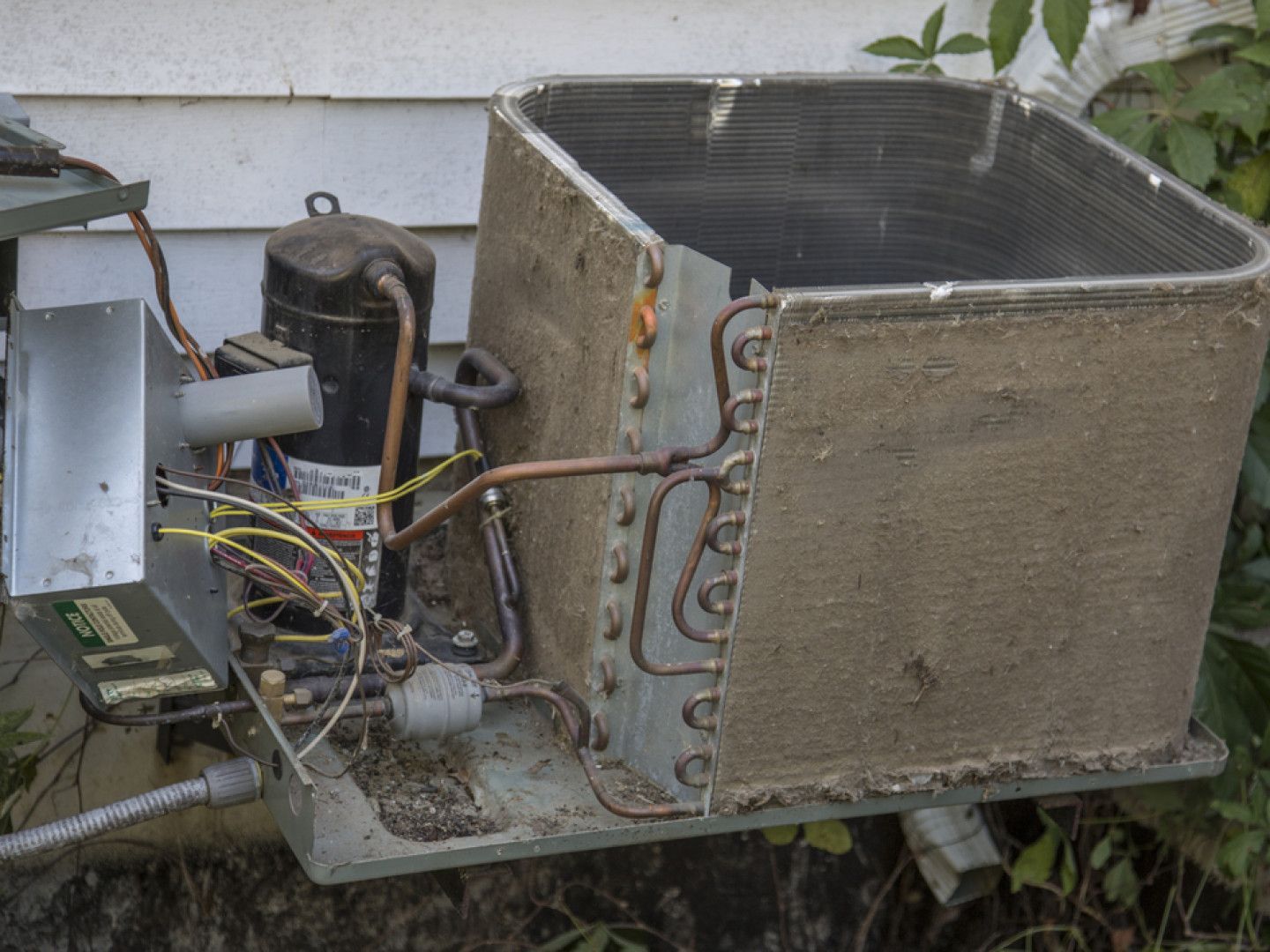 Close-up of a dirty air conditioner unit showing dust buildup.