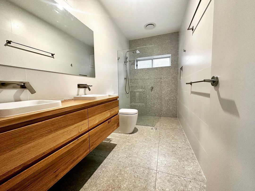 A Bathroom With Two Sinks, A Toilet And A Walk In Shower — Custom Design Bathroom Renovations in Port Macquarie, NSW