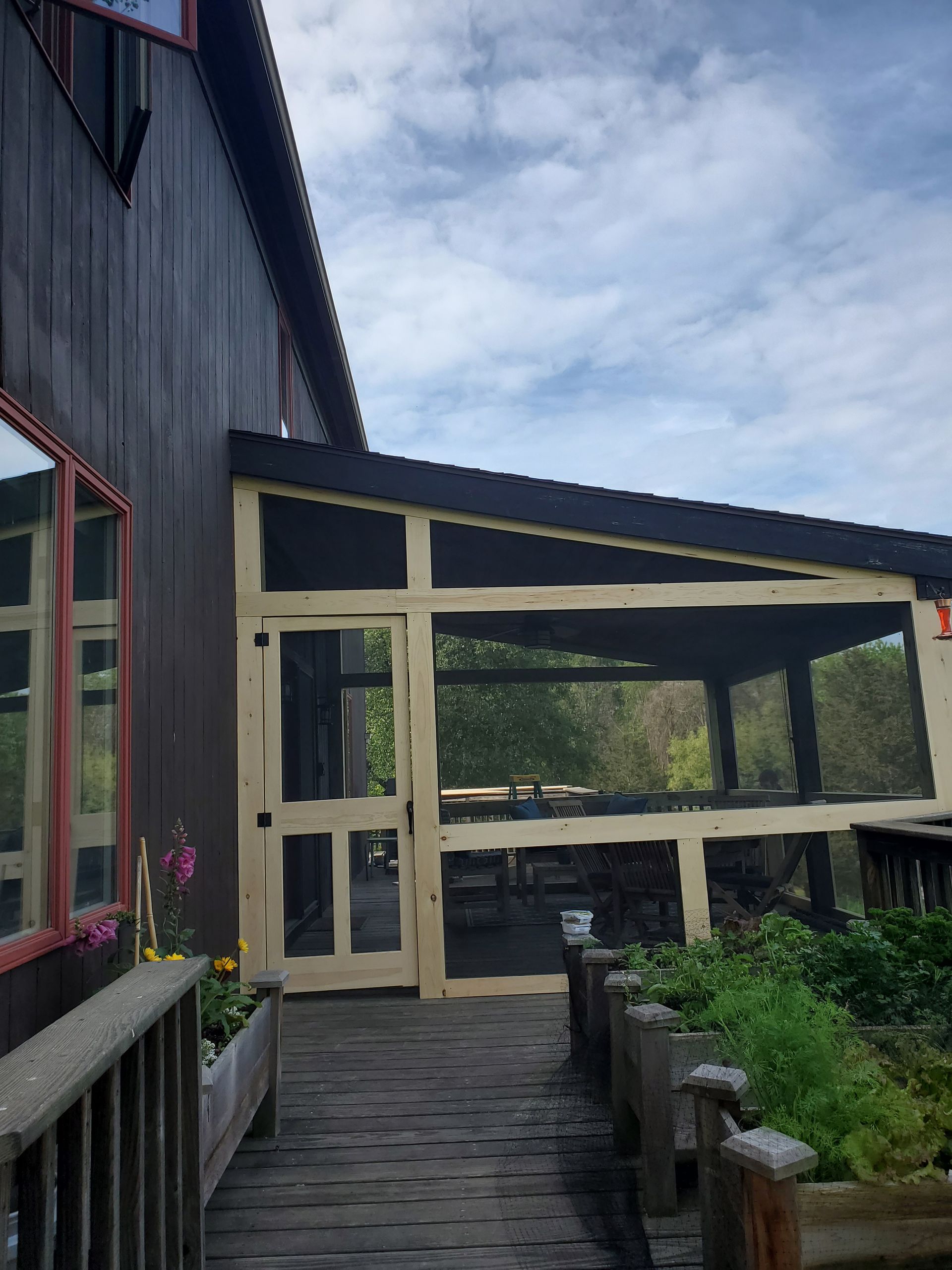 A building with a screened in porch and a sign that says exit