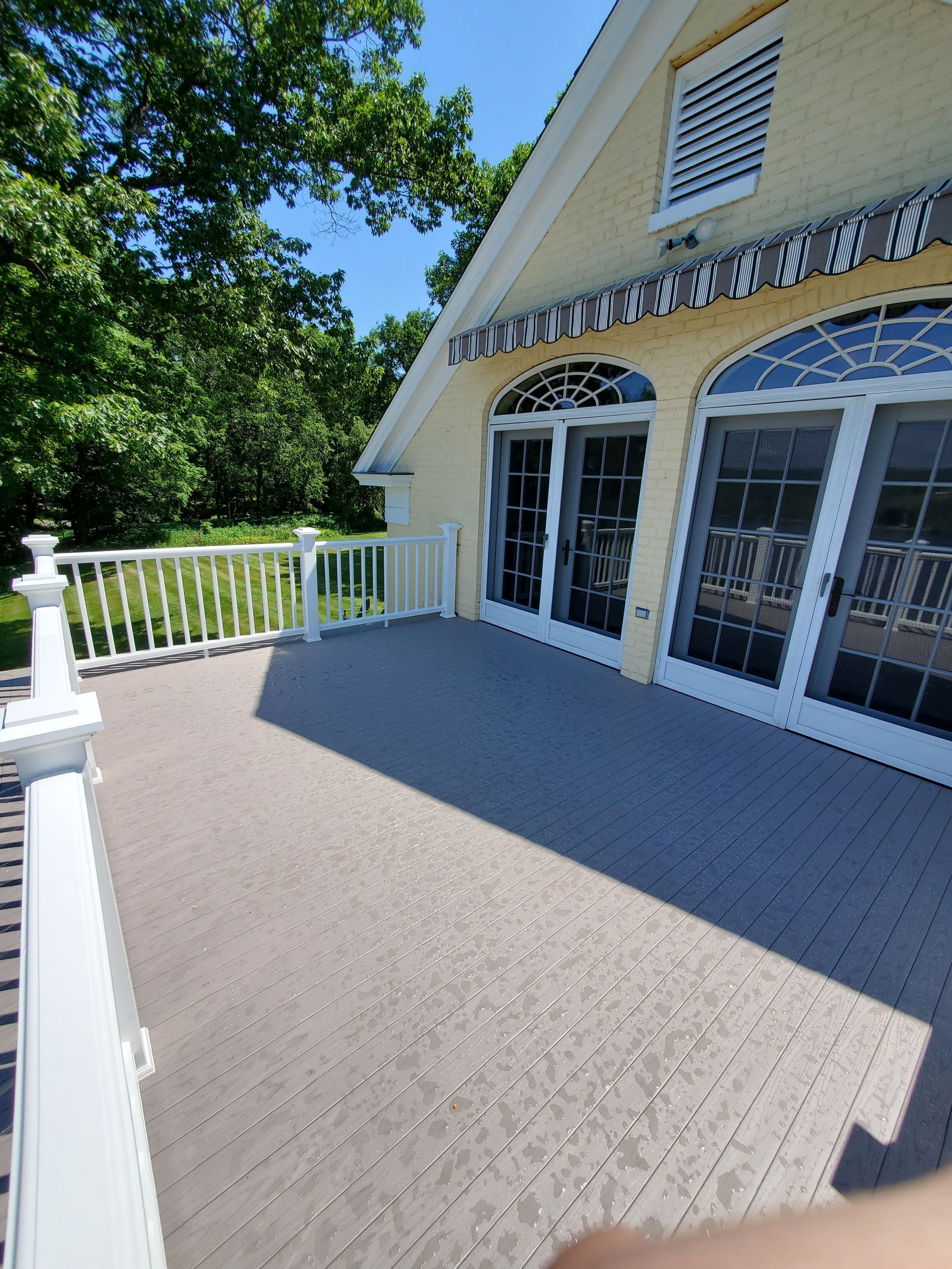 A large house with a balcony and sliding glass doors