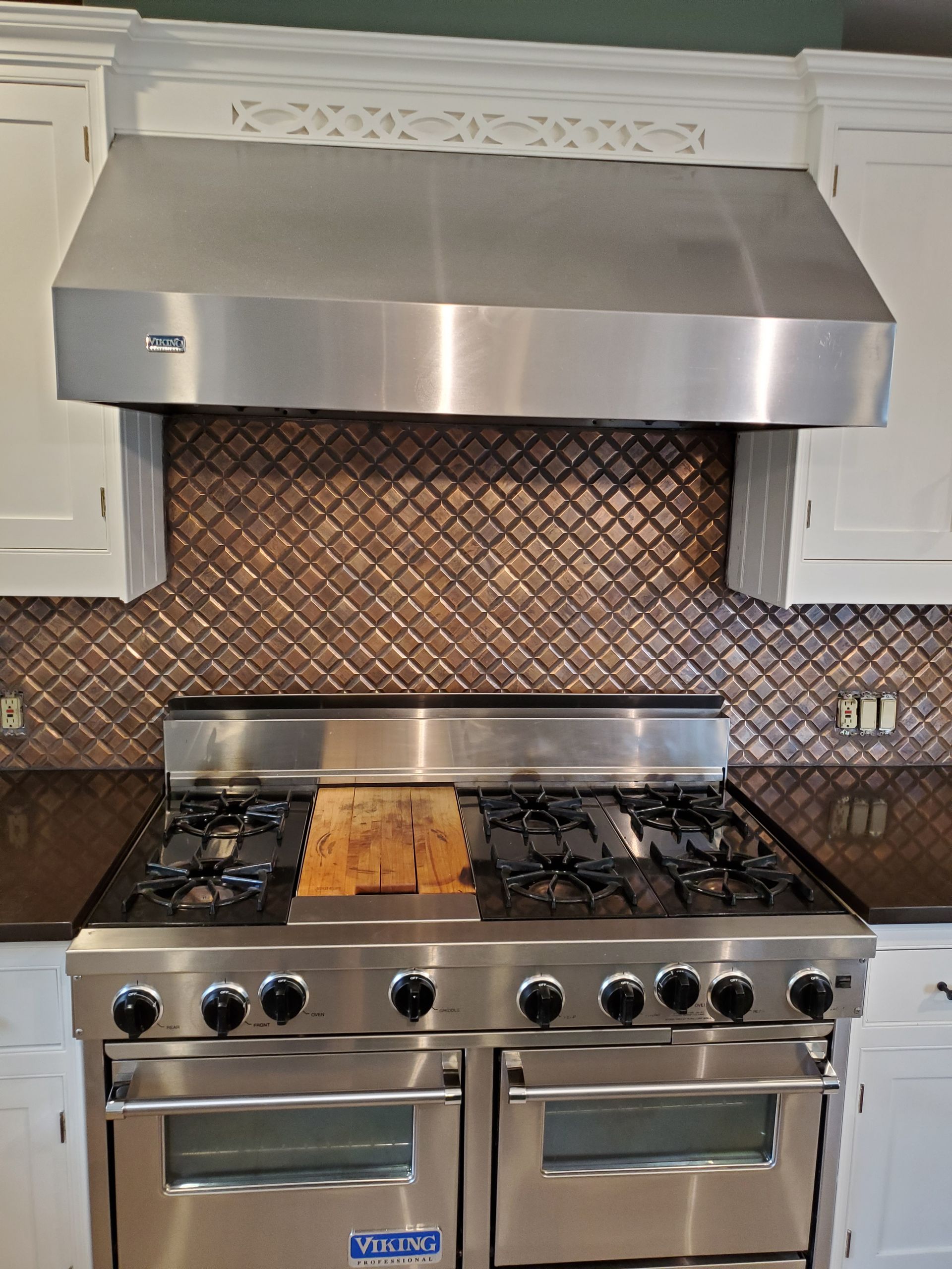 A kitchen with a stainless steel stove and oven