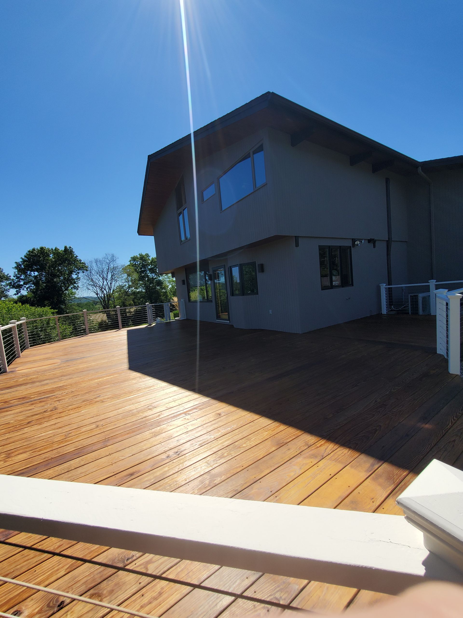A large house with a wooden deck in front of it