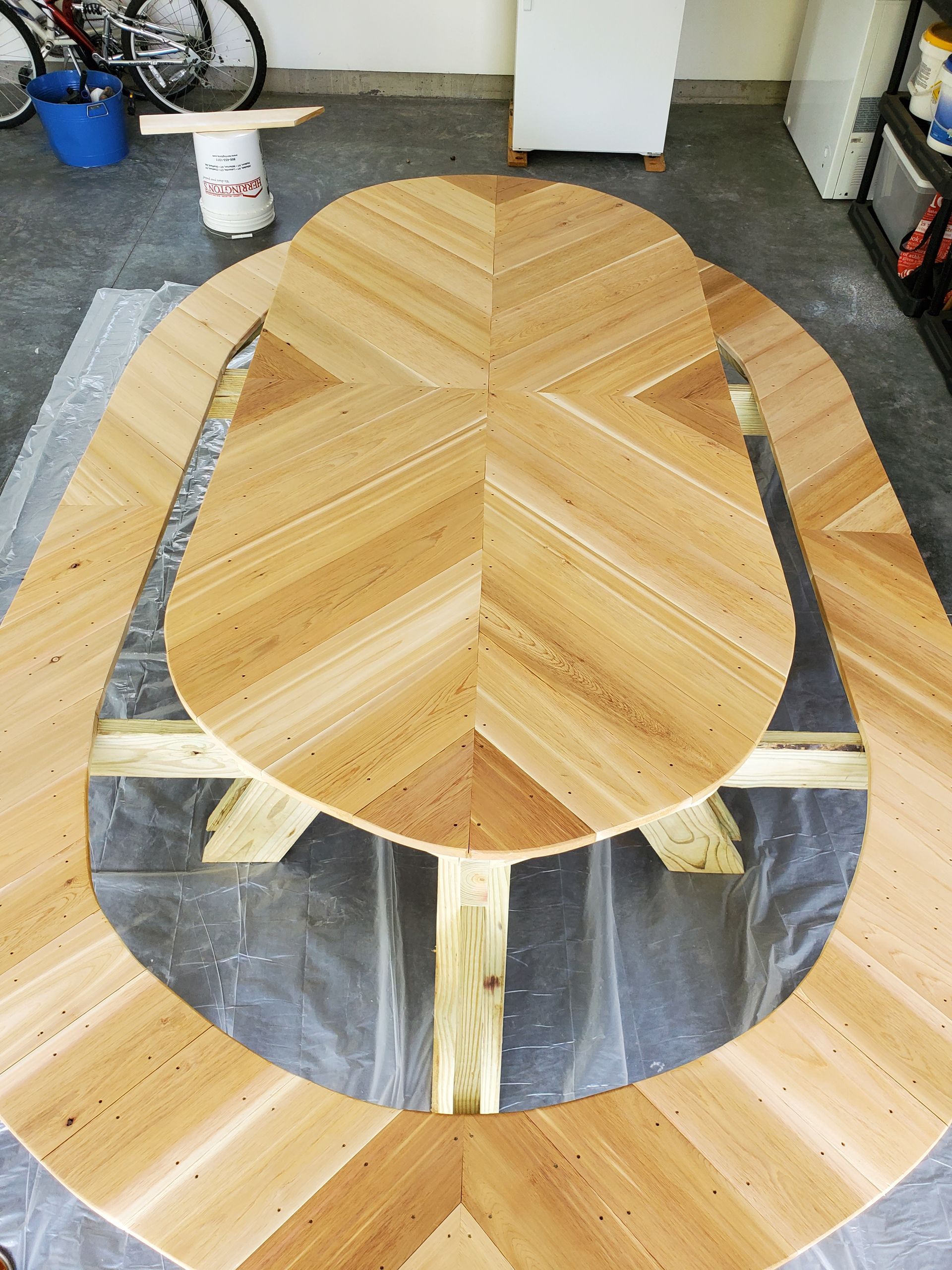 A wooden table that looks like a turtle is in a garage