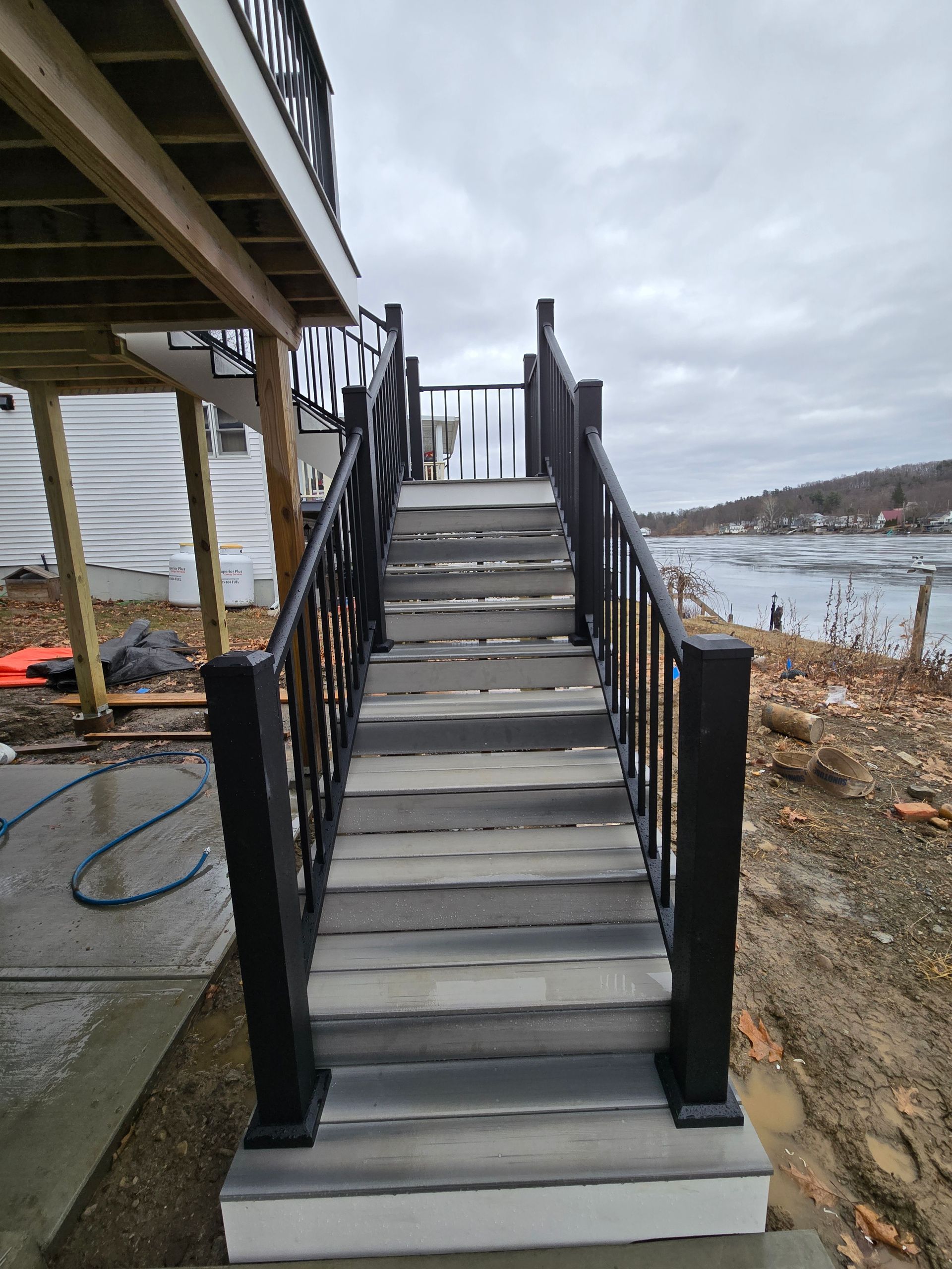 A set of stairs leading up to a deck with a railing.