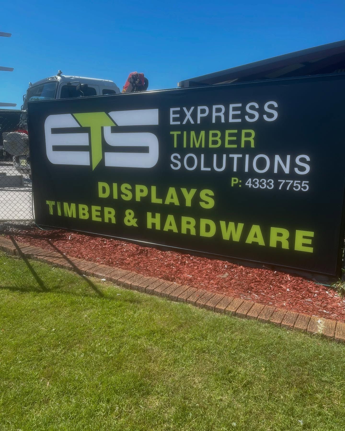 Sign for Ets, a Timber and Hardware Store, with Green Background and White Text — Express Timber Solutions In Long Jetty, NSW