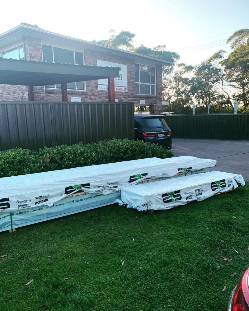 Two Large Bundles of Lumber Wrapped in Plastic — Express Timber Solutions In Long Jetty, NSW