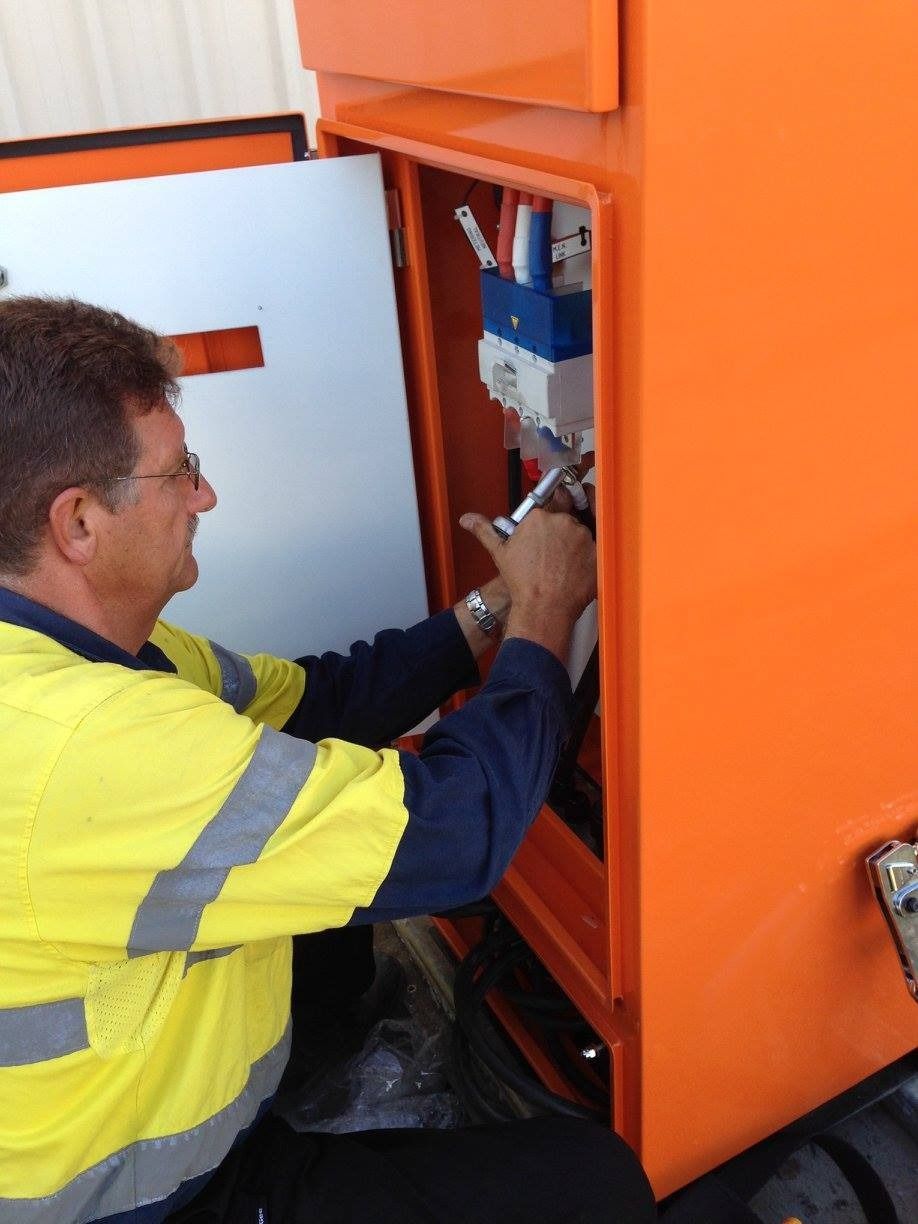 Electrician Working on Open Orange Panel