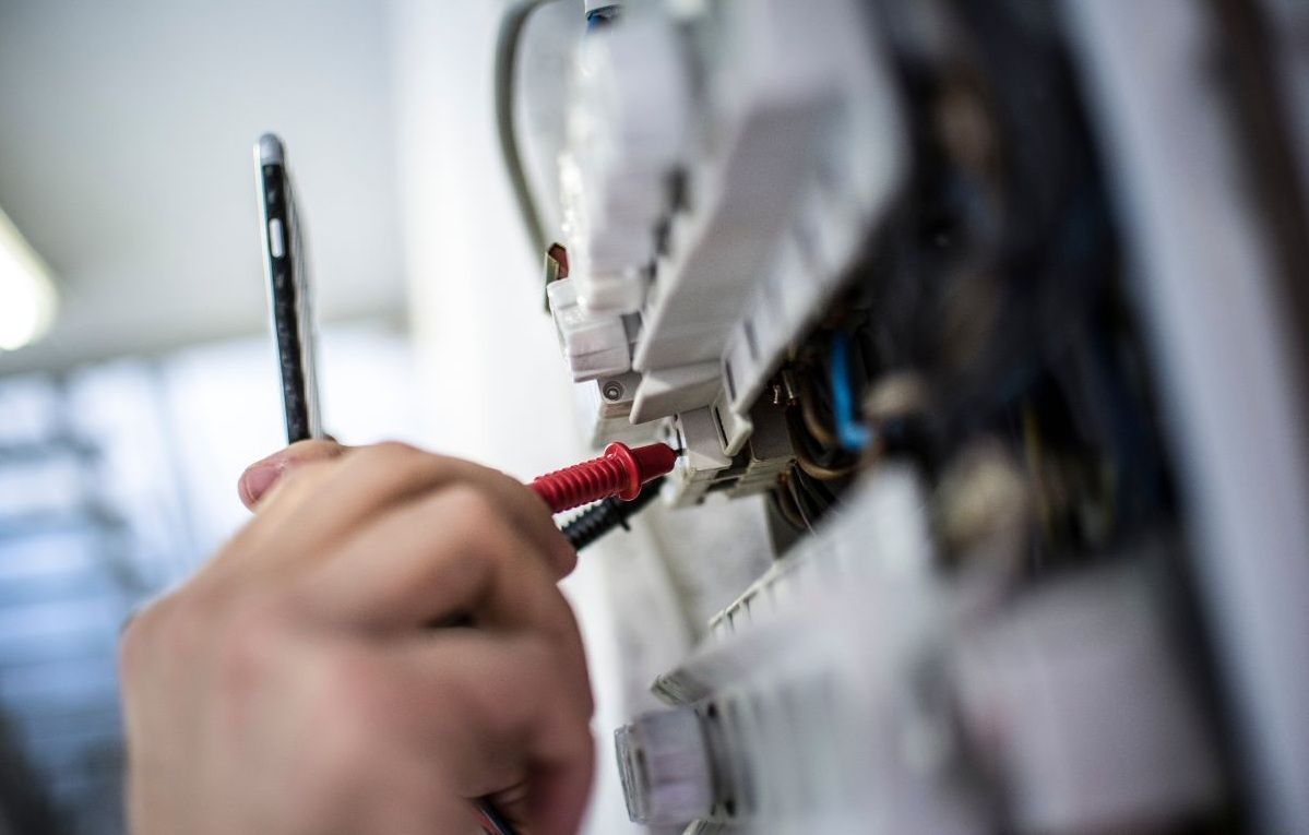 An Electrician Testing A Home Electrical Switchboard