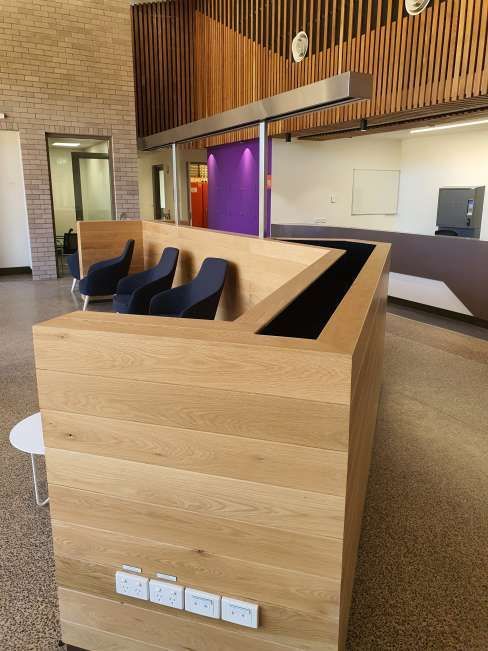 There is a wooden counter in the middle of the room.