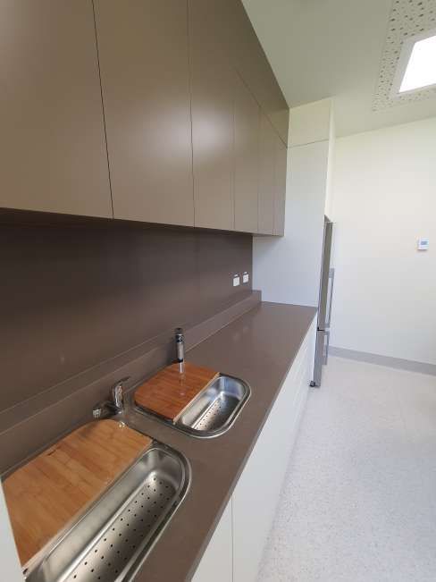 A kitchen with a sink and a cutting board