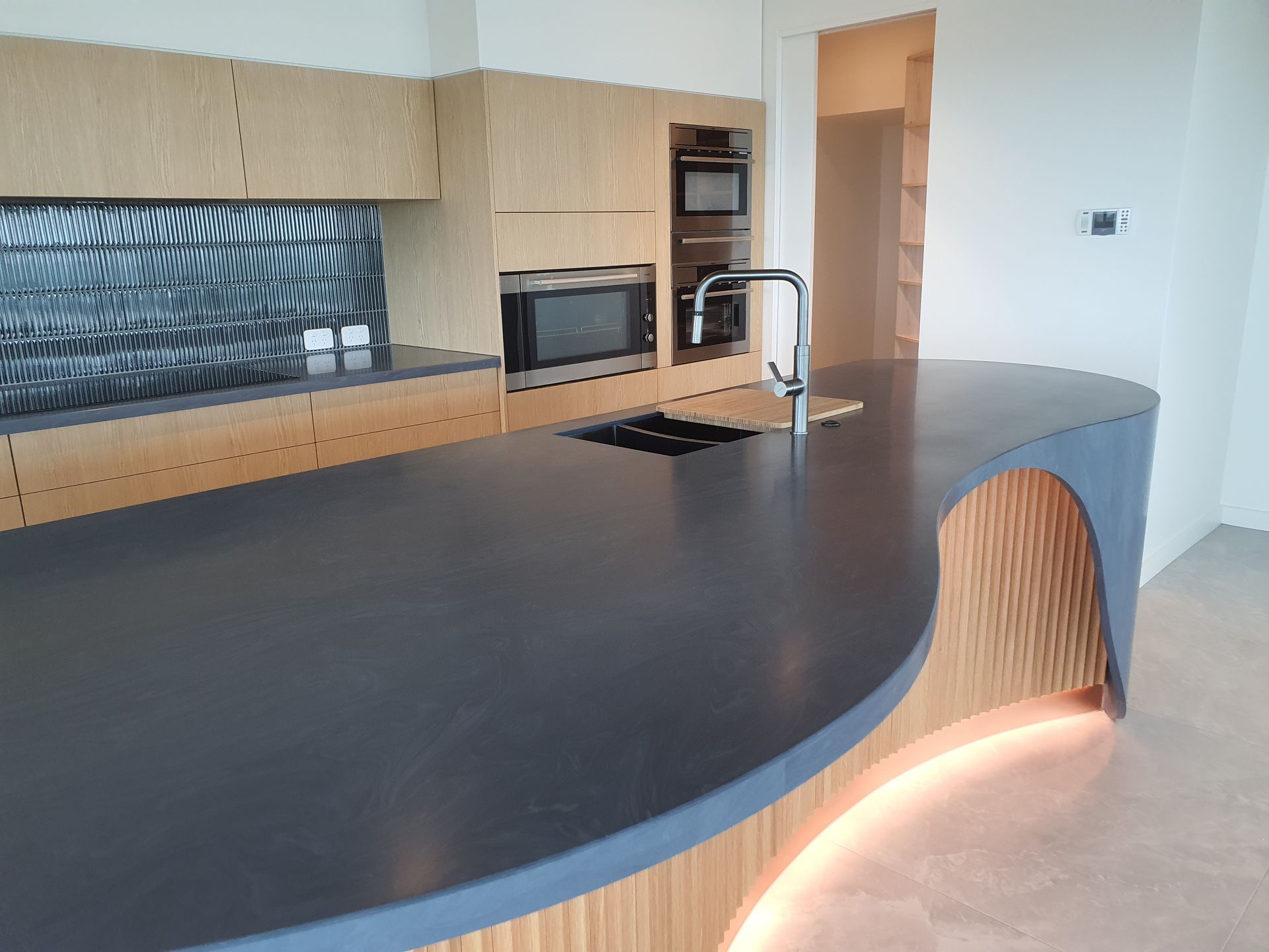 A kitchen with a large island and a sink