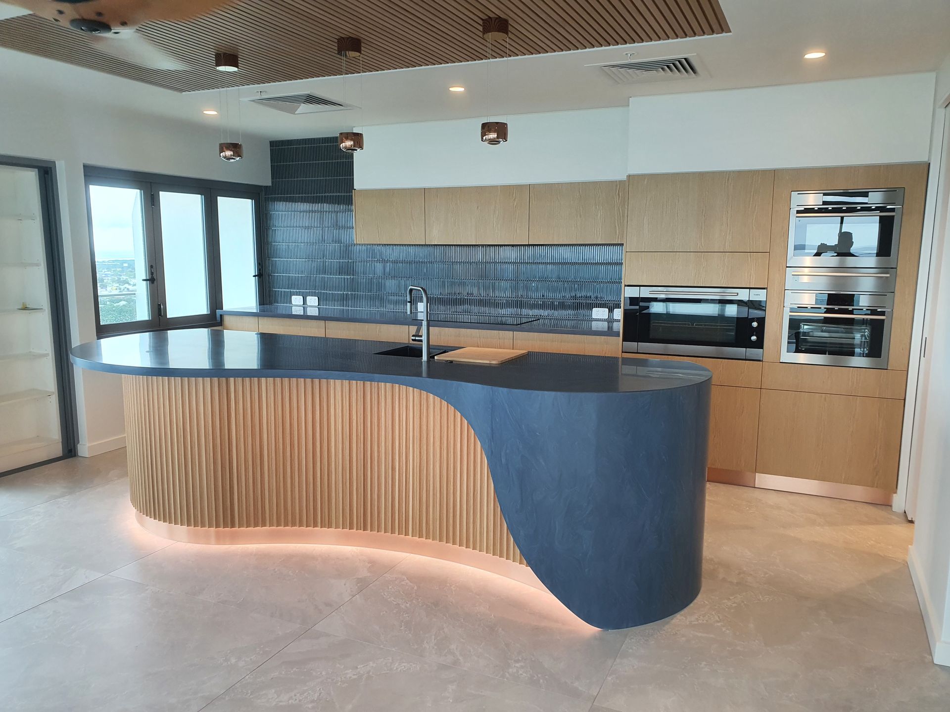There is a large island in the middle of the kitchen.