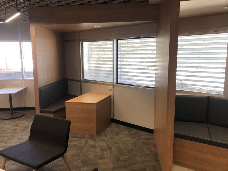 A room with a couch , chair , table and window.
