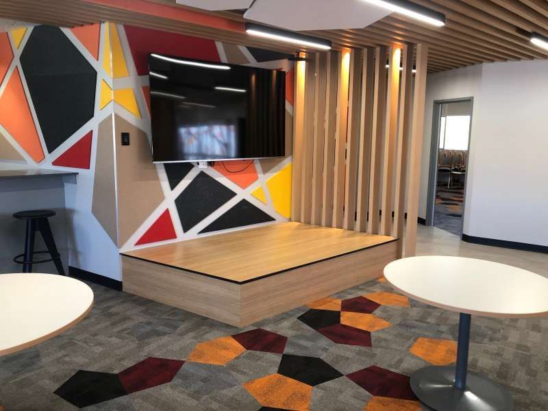 A room with tables and a television on the wall