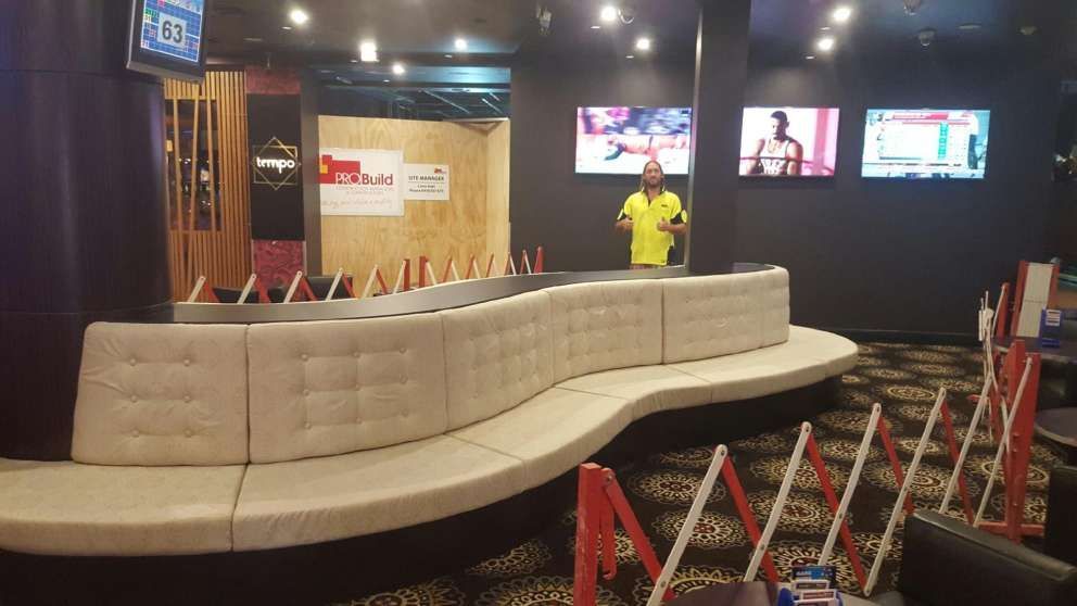 A room with a long couch.