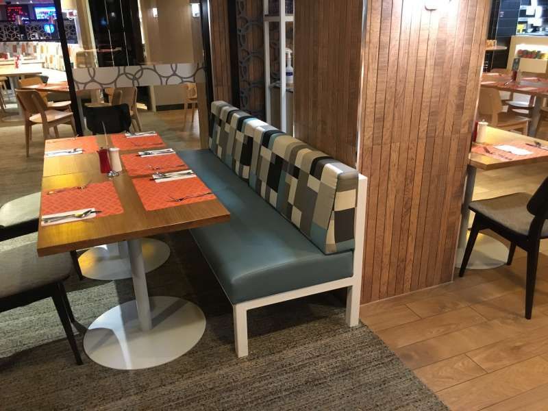 A restaurant with tables and chairs and a bench