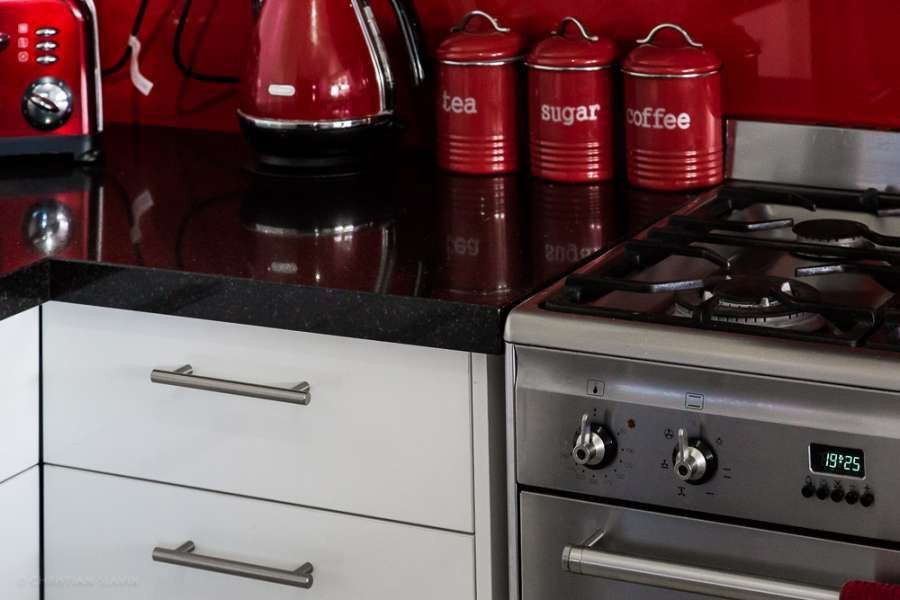 A kitchen with a stove top oven and a toaster oven