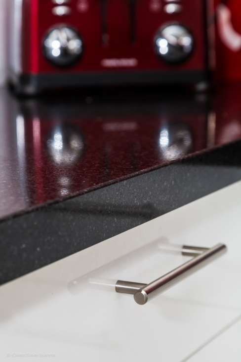 A kitchen counter with a red toaster in the background