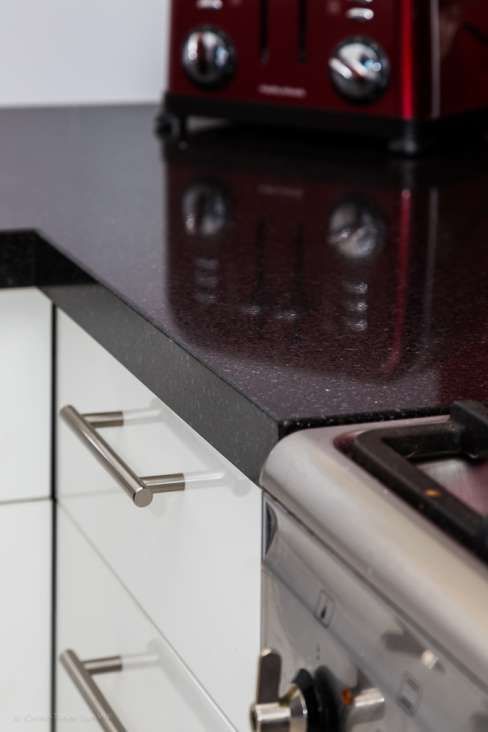 A kitchen counter with a red toaster on it