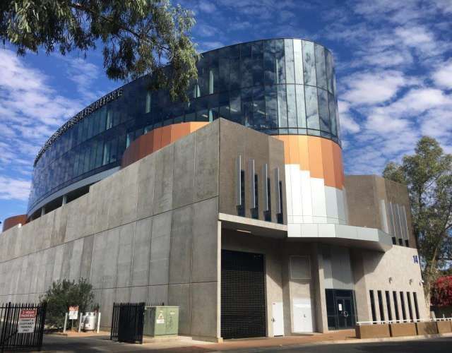 A large building with a lot of windows is for sale