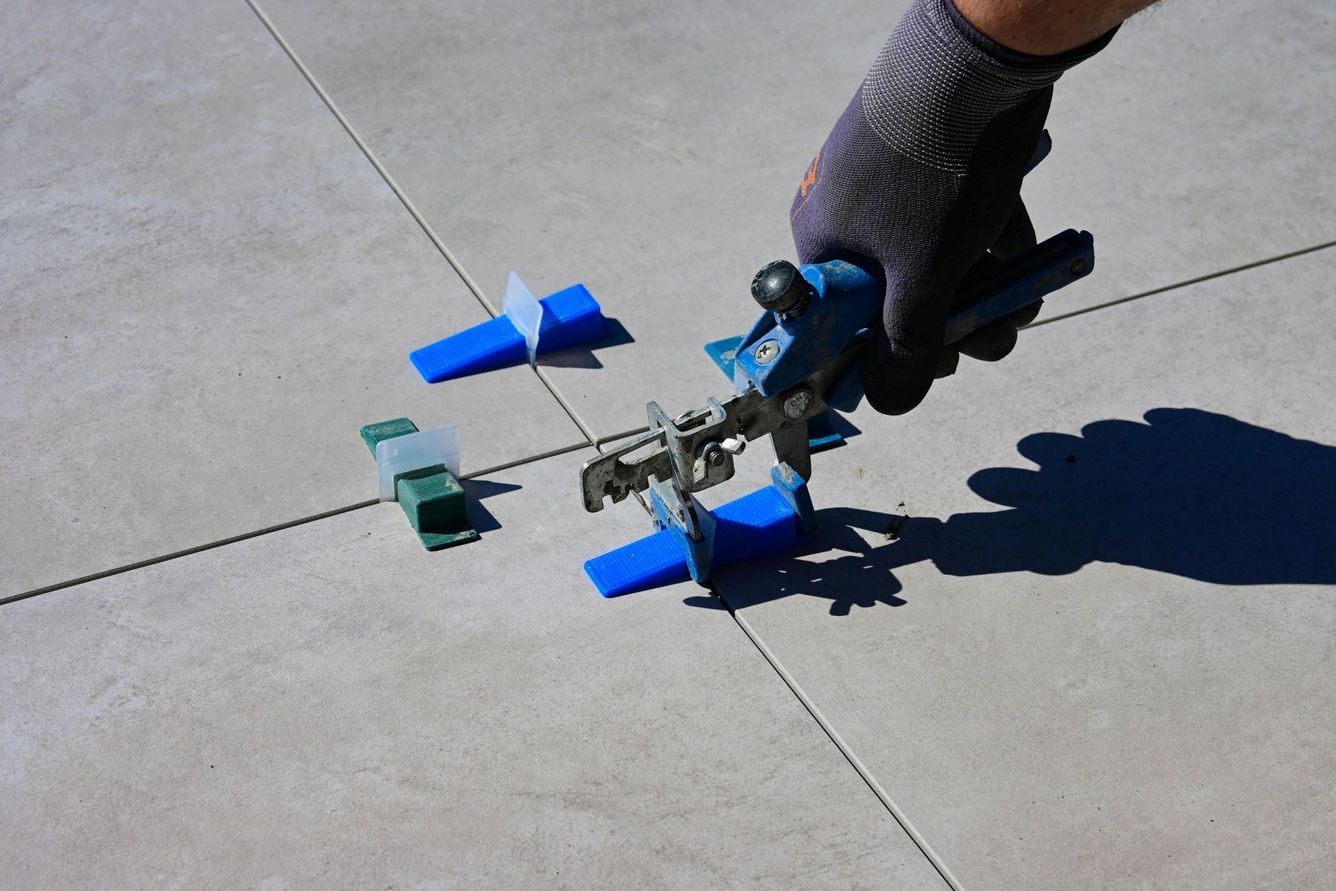 A professional is installing a tile