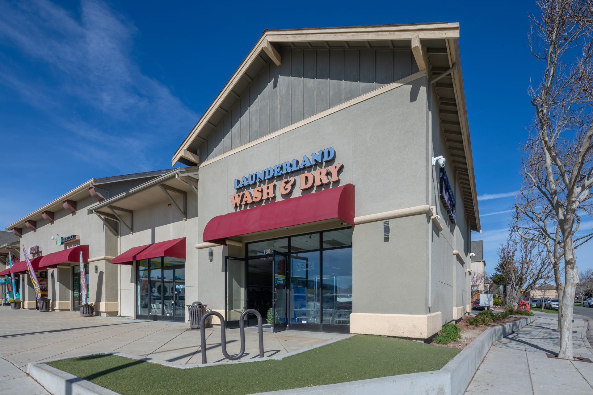 Shopping center storefront with a “Launderland Wash & Dry