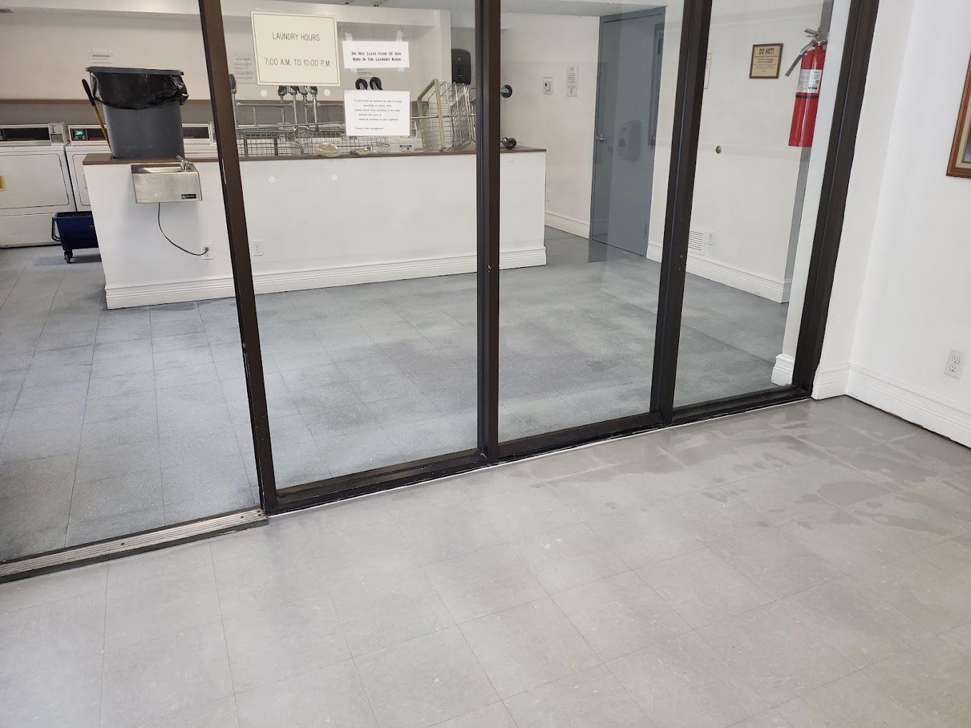 A room with a sliding glass door leading to a kitchen.