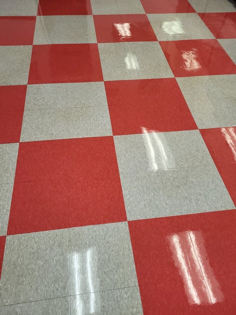 A red and white checkered floor with a reflection of lights
